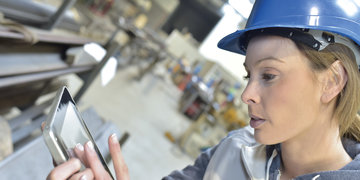 Woman engineer in steel plant checking production | © stock.adobe.com/77081549